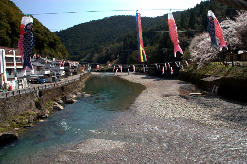 A view of Kawayu Onsen with carp flags flying above the river -- truly an idyllic place to bathe.