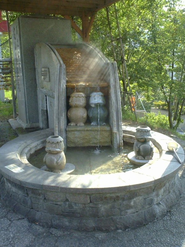 Kappa statues in a fountain near the bus stop.